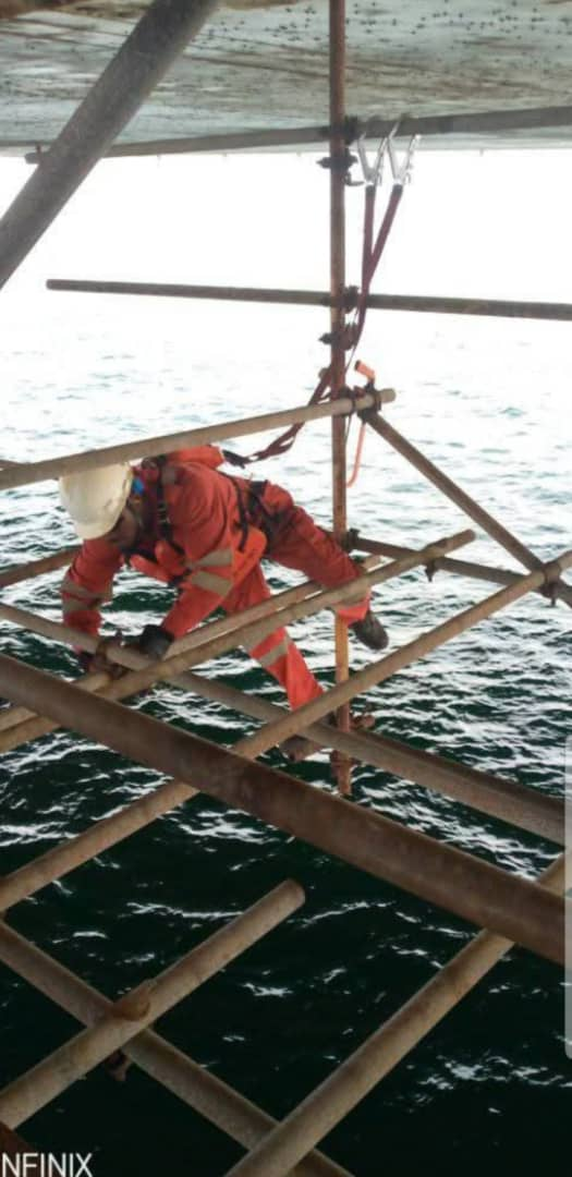 Scaffolder working beneath an offshore platform deck