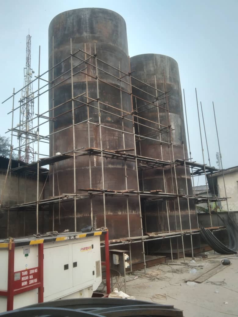 Scaffold access built around twin storage tanks