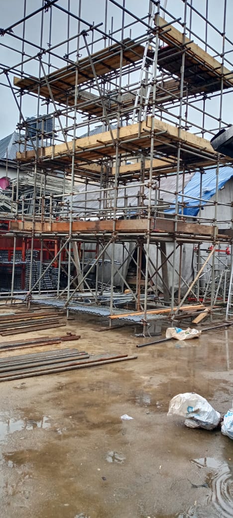 Multi-lift birdcage scaffold with timber boards on a work site