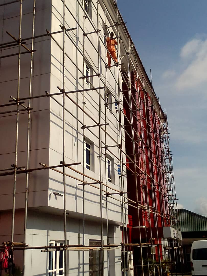 Facade access scaffold with crew at height